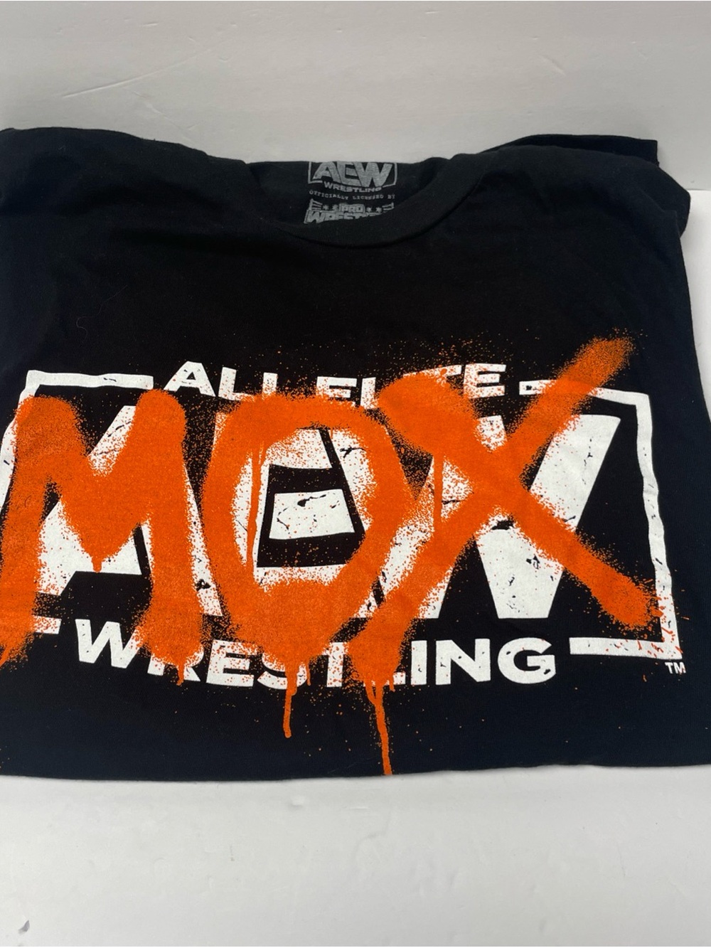 WWE Black Short-Sleeve Tee with Orange 'MOX' Spray Graphic